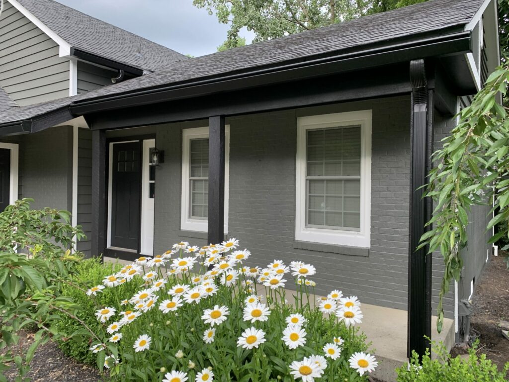 Home with black K-Guard Gutters Showcasing Downspout